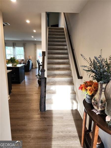 stairs featuring wood-type flooring