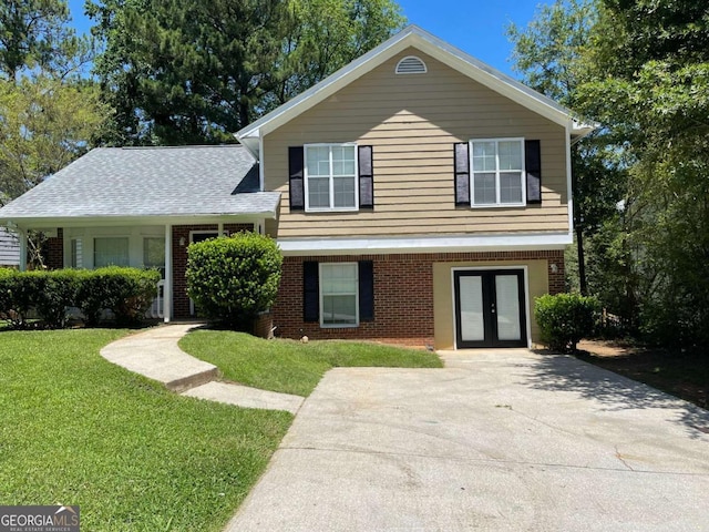 split level home featuring a front yard and french doors