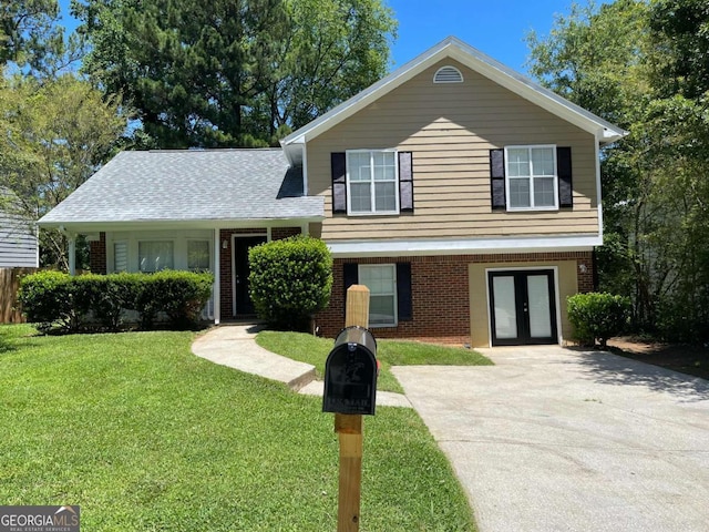 split level home featuring french doors and a front lawn