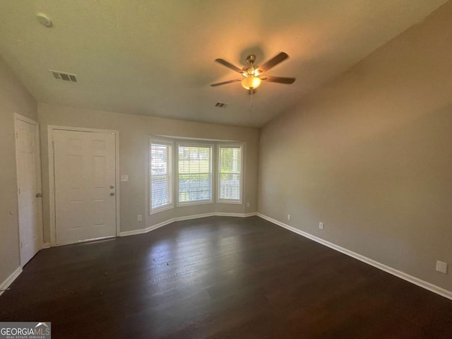 unfurnished room with vaulted ceiling, ceiling fan, and dark hardwood / wood-style flooring