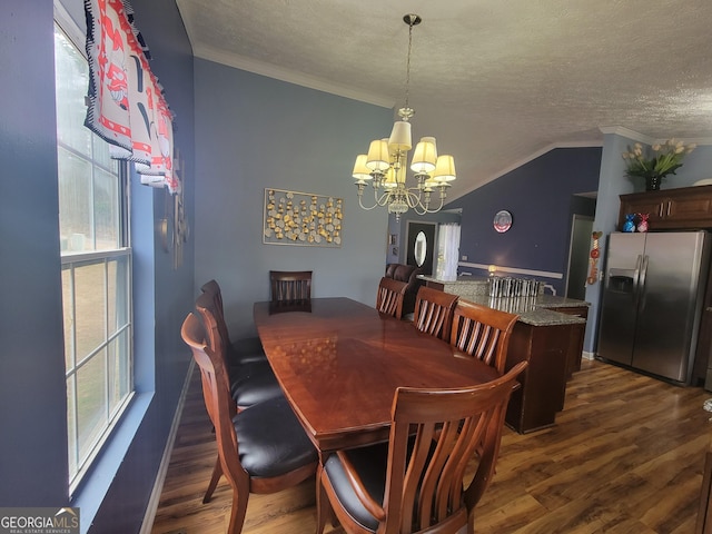 dining room with a notable chandelier, a textured ceiling, dark wood finished floors, and crown molding