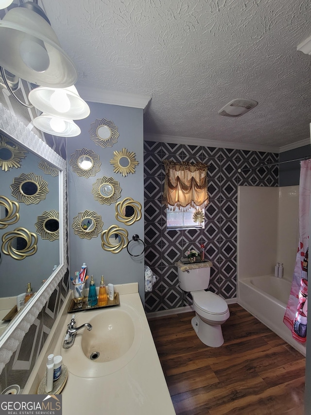 bathroom with shower / bathtub combination with curtain, toilet, a textured ceiling, wood finished floors, and crown molding