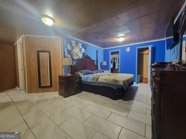 bedroom with a walk in closet, wooden ceiling, a closet, and ornamental molding