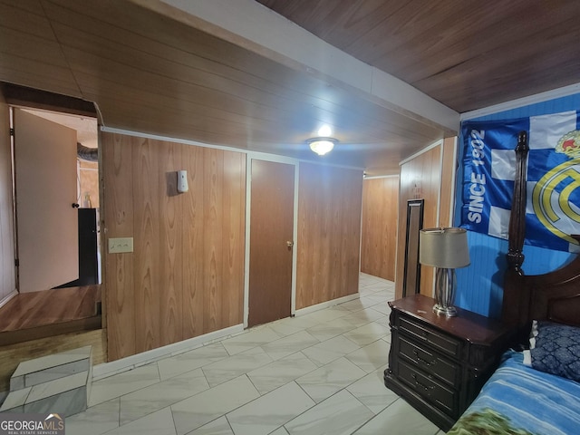 bedroom with wooden ceiling and wood walls