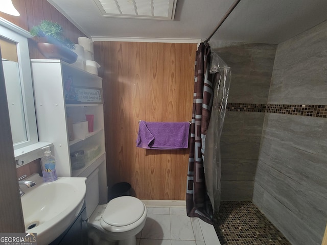 bathroom with a sink, toilet, visible vents, and tiled shower