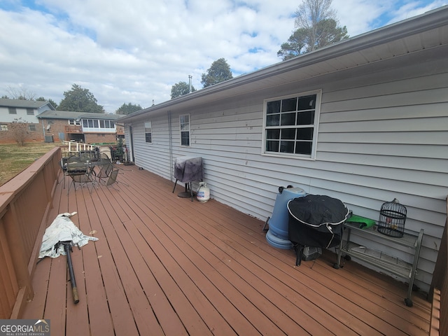 wooden deck featuring a grill