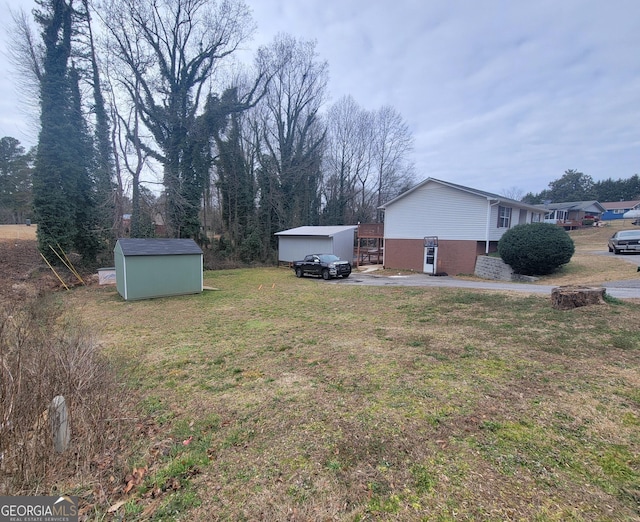 view of yard featuring a storage unit and an outbuilding