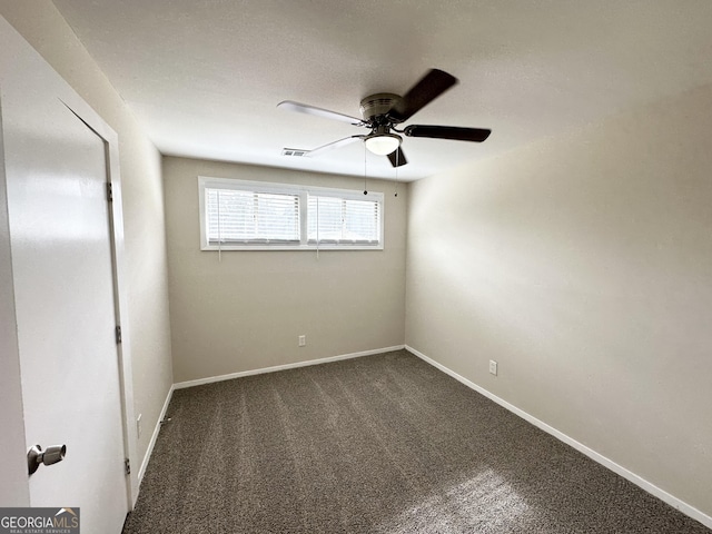 spare room featuring carpet floors and ceiling fan