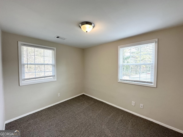 carpeted empty room featuring plenty of natural light