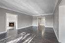 unfurnished living room featuring ornamental molding