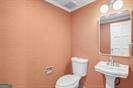 bathroom with crown molding and toilet