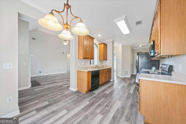 kitchen featuring ornamental molding, appliances with stainless steel finishes, sink, and hardwood / wood-style floors