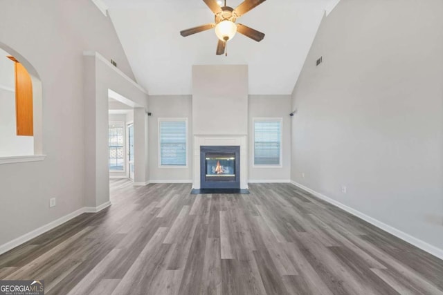 unfurnished living room featuring ceiling fan, hardwood / wood-style floors, and high vaulted ceiling