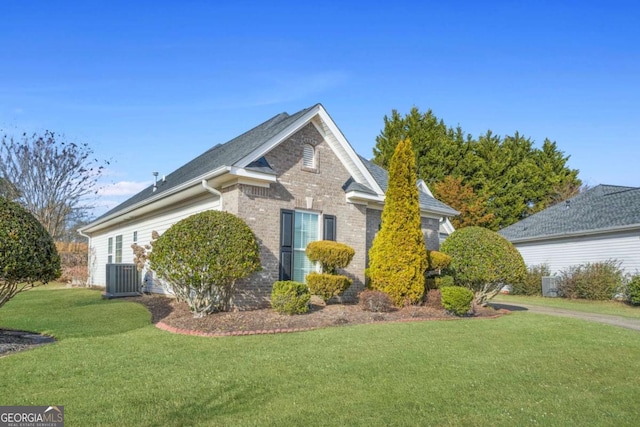 view of home's exterior featuring central AC unit and a yard