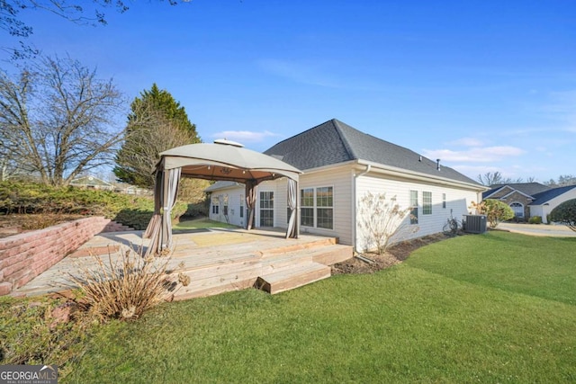 back of house with a yard, a gazebo, central air condition unit, and a wooden deck