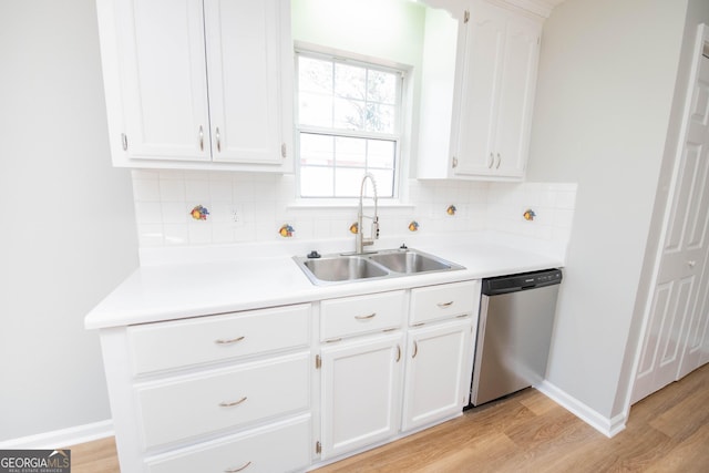 kitchen featuring white cabinetry, sink, stainless steel dishwasher, and light hardwood / wood-style floors