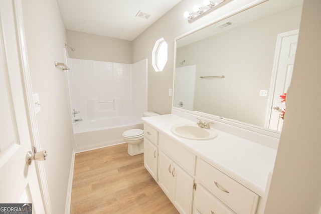 full bathroom featuring shower / bath combination, vanity, hardwood / wood-style floors, and toilet