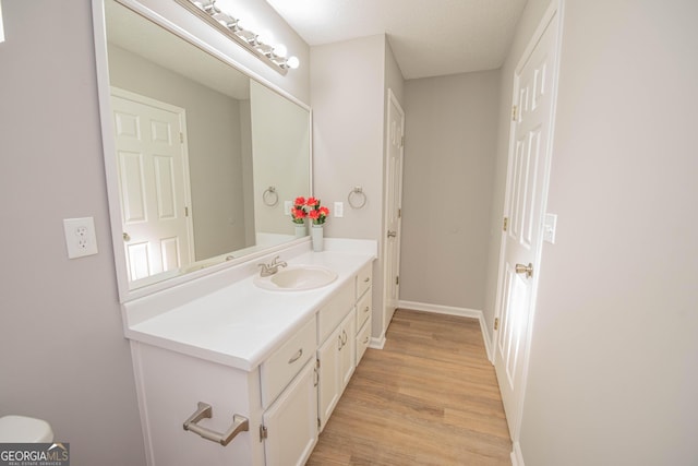 bathroom featuring vanity and hardwood / wood-style floors