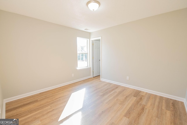 empty room with light hardwood / wood-style floors