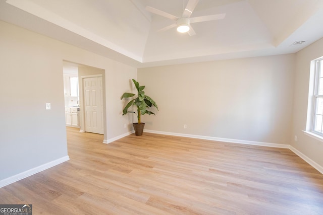 empty room with ceiling fan and light wood-type flooring