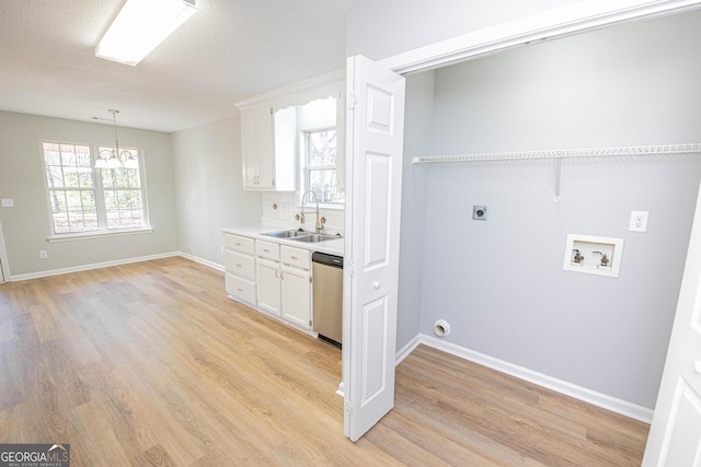 washroom with sink, a chandelier, hookup for a washing machine, electric dryer hookup, and light hardwood / wood-style floors