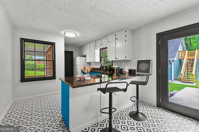 interior space with a textured ceiling, french doors, baseboards, light floors, and visible vents