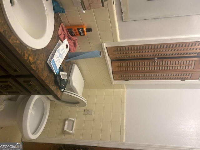 bathroom with tile walls and toilet