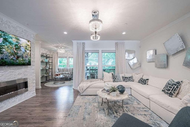 living room featuring crown molding, hardwood / wood-style floors, and a fireplace