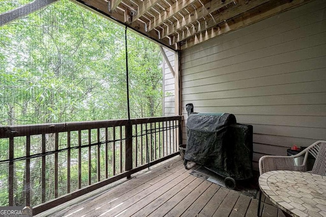 wooden deck featuring a grill