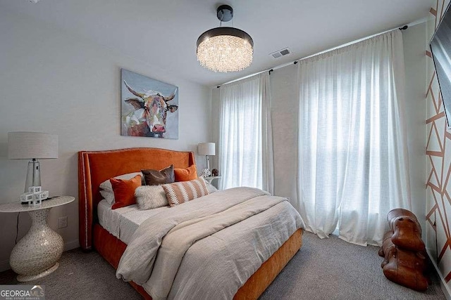 bedroom with an inviting chandelier and carpet flooring