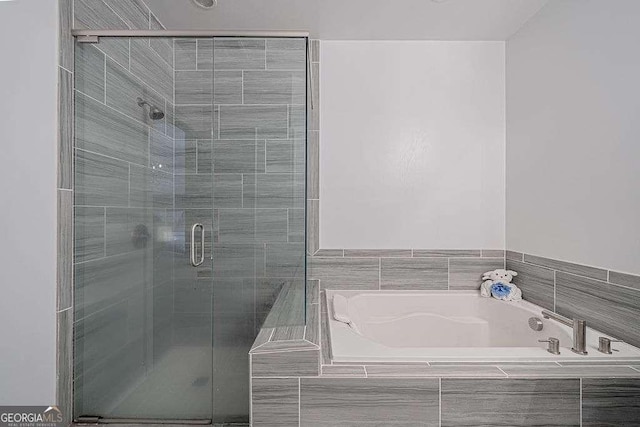 bathroom featuring separate shower and tub