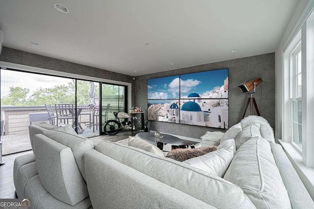 living room with wood-type flooring and plenty of natural light