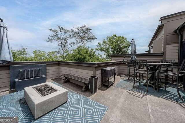 view of patio featuring an outdoor fire pit and an outdoor bar