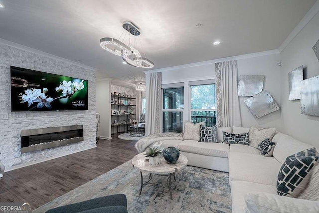 living room with ornamental molding, a stone fireplace, and wood-type flooring