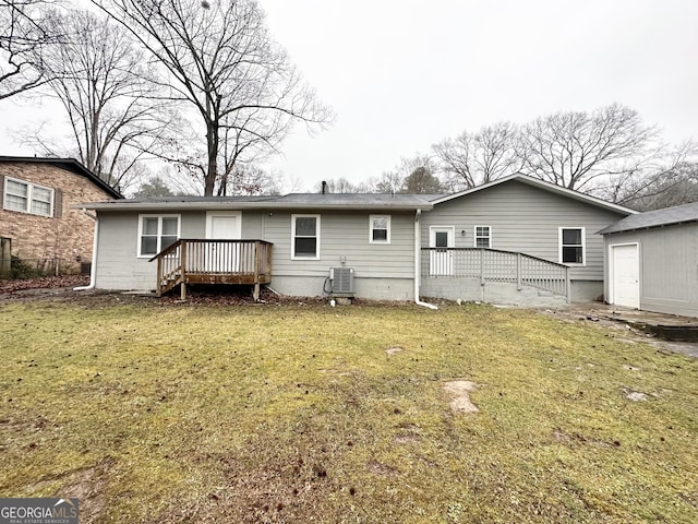 back of property featuring central AC unit, a lawn, and a deck