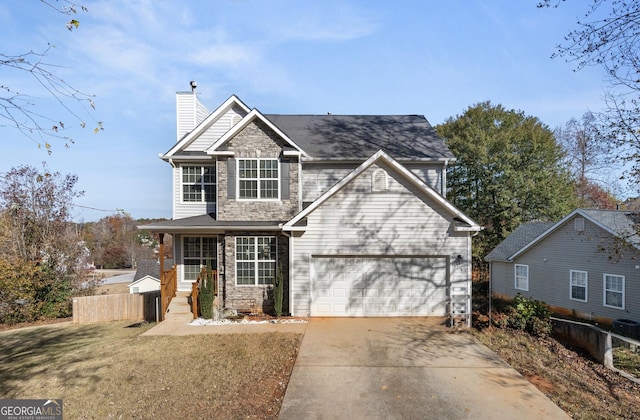 view of front of property featuring a garage, covered porch, and a front lawn