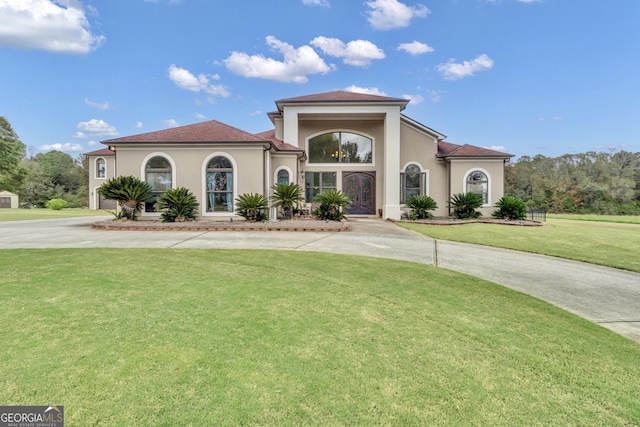 mediterranean / spanish-style home featuring a front lawn