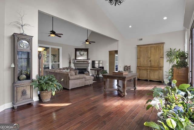 living room featuring high vaulted ceiling and dark hardwood / wood-style flooring