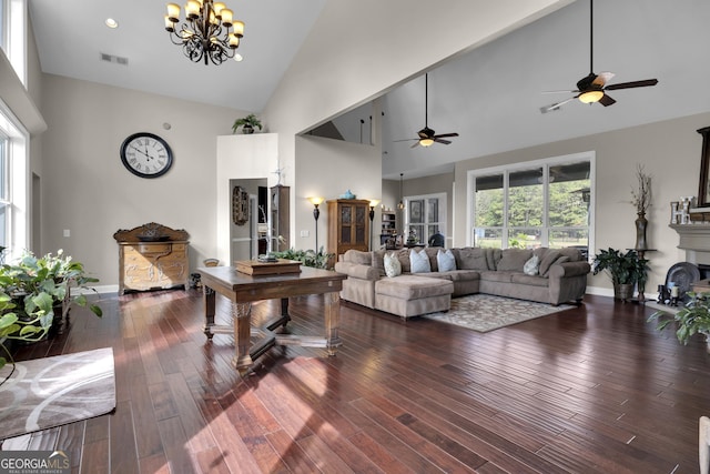 living room featuring high vaulted ceiling, dark hardwood / wood-style floors, and a chandelier