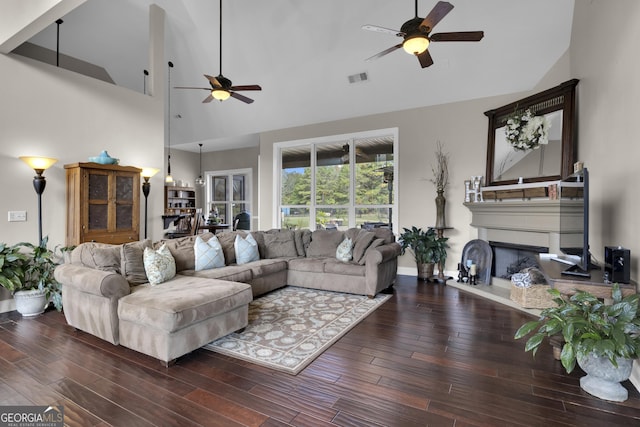 living room featuring hardwood / wood-style flooring, ceiling fan, and high vaulted ceiling