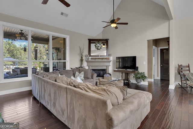 living room with ceiling fan, dark hardwood / wood-style flooring, and high vaulted ceiling