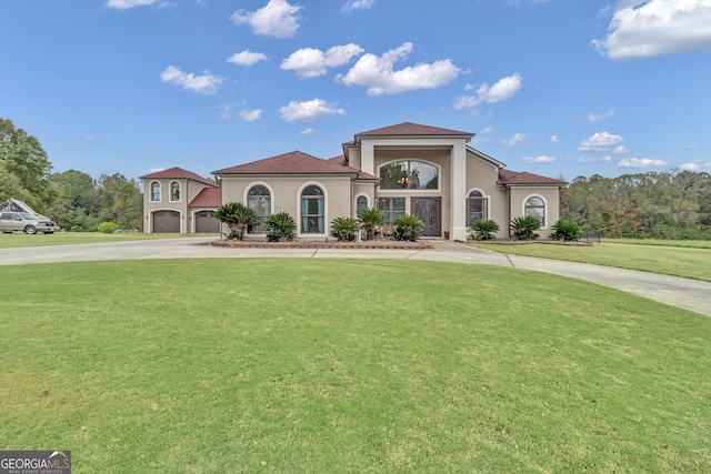 mediterranean / spanish house with a front yard