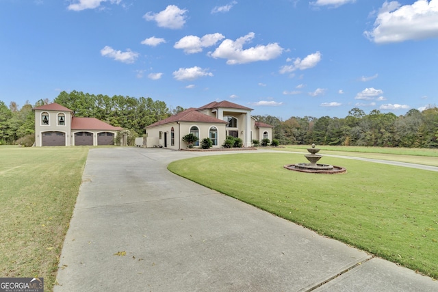 mediterranean / spanish-style house featuring a garage and a front lawn