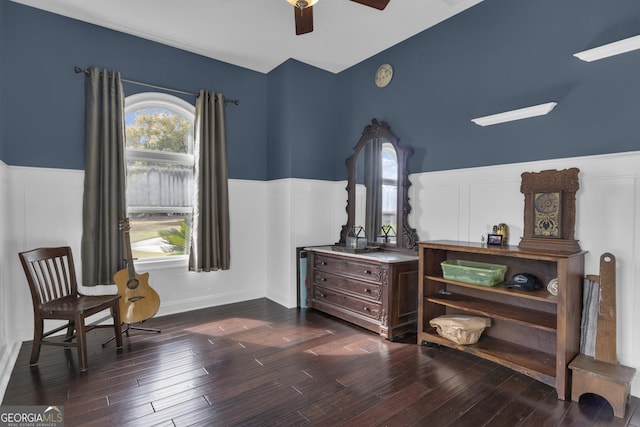 living area featuring dark hardwood / wood-style flooring and ceiling fan