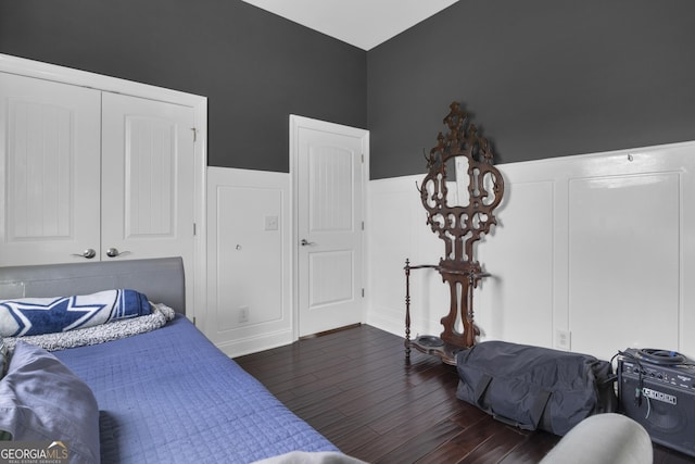 bedroom featuring dark hardwood / wood-style flooring and a closet