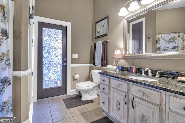 bathroom with vanity, tile patterned floors, and toilet