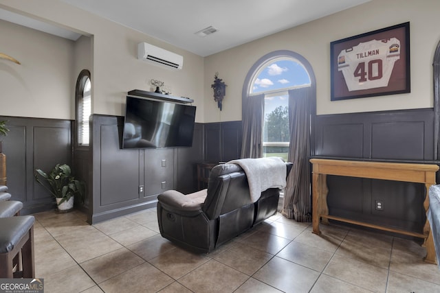 living room with tile patterned flooring and a wall unit AC