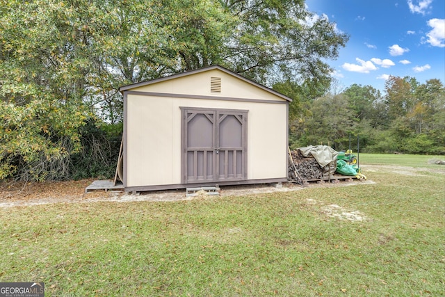 view of outdoor structure with a lawn