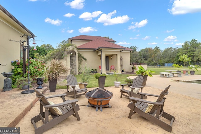 view of patio / terrace featuring an outdoor fire pit