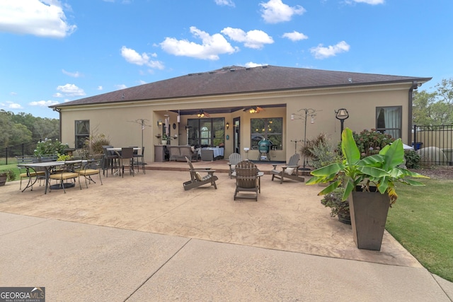 back of property with ceiling fan and a patio area